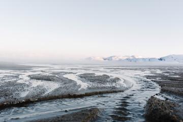 the low tide in the North sea in winter on a frosty day exposed the bottom with sand and ice
