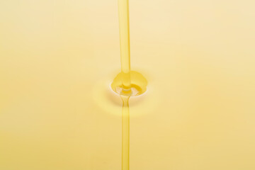 Pouring of fresh olive oil, closeup