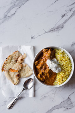 Indian curry in a bowl with cauliflower naan bread on the side