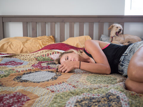 Staring At Cell Phone In Bed