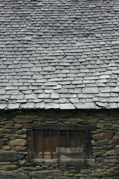 Detail of an slate roof of an old stone house