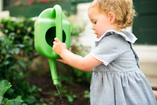 Two young twins playing outside in the summertime