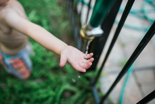 Two young twins playing outside in the summertime