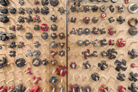 Woodworking Accessories cutters and blades on wooden wall