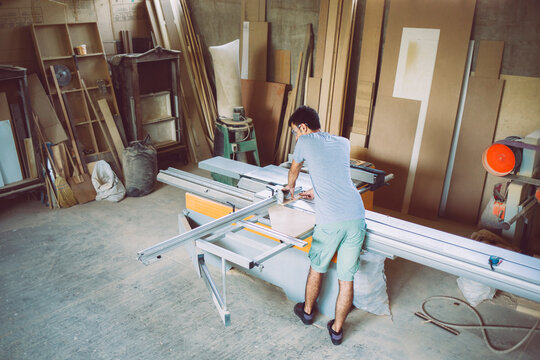Carpenter Measuring a Plank