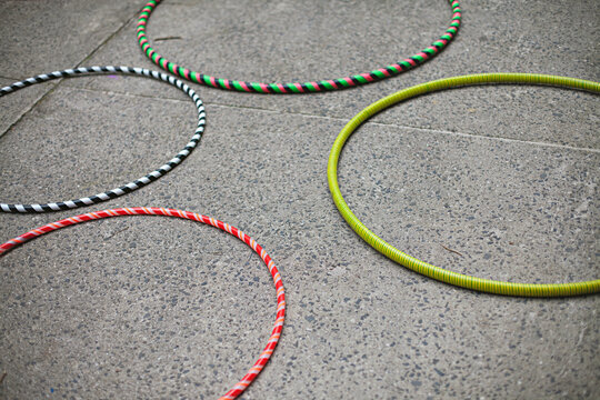 colourful hula hoops discarded on the ground