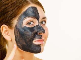 Woman with charcoal facial mask