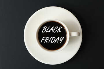 Cup of coffee on black background, top view