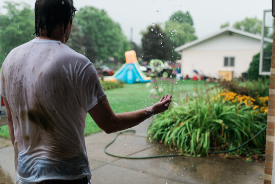 A man and a woman standing out in the rain