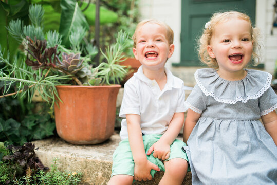 Two young twins playing outside in the summertime