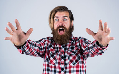 oh my god. Portrait of bearded hipster. guy with long lush beard and mustache on face. handsome confident man has perfect hairstyle. surprised bearded man in checkered shirt. male beauty concept
