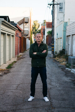 portrait of middle aged male in urban alley way city
