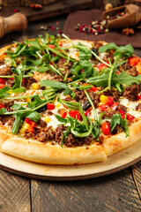 Closeup on pizza with minced meat and arugula