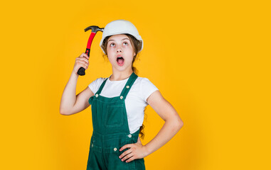 oh my god. hammering. she is good assistant. Kid engineer with carpenter work hammer. Labor day at 1 may. little girl in hard hat holds hammer. best repairer ever. learning to use hammer