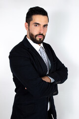 Handsome young bearded man in suit with crossed arms. Attractive stylish businessman. Medium shot. White background.
