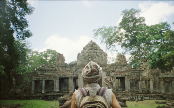 Backpacker walking around Angkor Wat temple area in Siem Reap, Cambodia