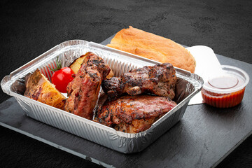 Grilled veal steak with baked potatoes, matnakash and red sauce.  Food delivery. Served on...
