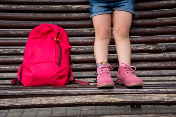 Little girl at her first day of school with her red satchel