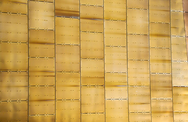Golden bronze alloy roofing tiles shining in the summer sunshine