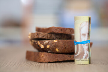 Canadian dollar bills and black bread