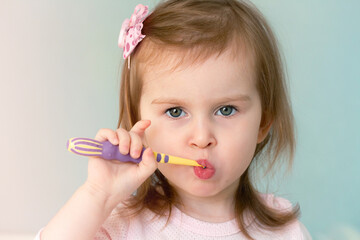 Girl 2 years old learn to brush her teeth