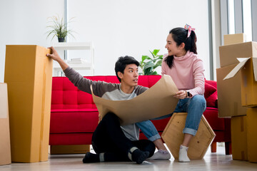 Happy young couple moving to new house together.