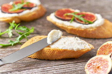 Bread snack  with soft white cheese and figs. Healthy vegetarian appetizer.