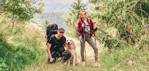 Young girl and man trekking mountain