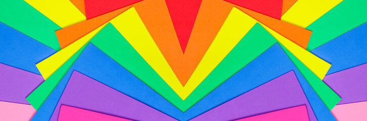 An abstract geometric textured background of multicolored rainbow colors created with overlapping foam craft paper 