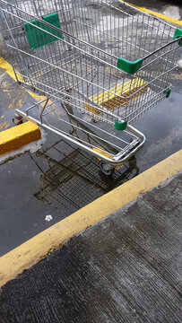Empty grocery shopping cart left abandoned in the parking lot.