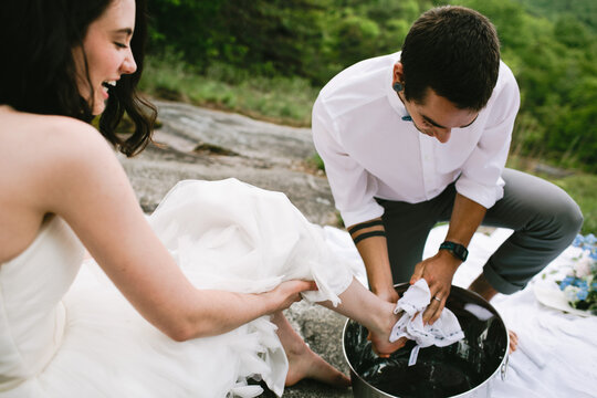 groom washing his bride's feet