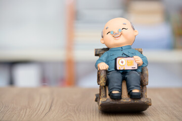 Smiling old grandpa model on the table