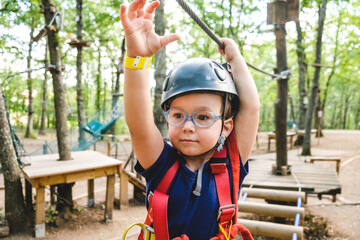 Toddler Boy Having Fun on a Ropes Course