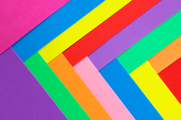 An abstract geometric textured background of multicolored rainbow colors created with overlapping foam craft paper 