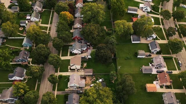 Aerial drone view of American suburban neighborhood. Establishing shot of America's  suburb. Residential single family houses pattern. Autumn Fall season
