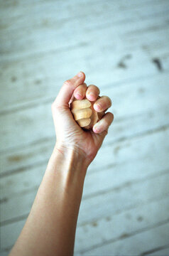 Wooden massage ball in the hand