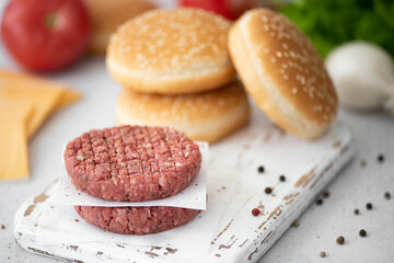 ingredients for making a hamburger - meat cutlet, bun, cheese, vegetables