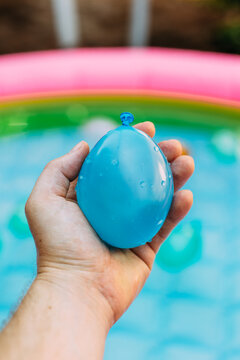 Colorful Blue Water Balloon In Palm Of Hand