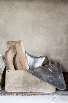 Masonry tools in a box on a shelf