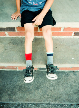 child with mismatched socks