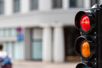 traffic control semaphore with red light on a defocused city background