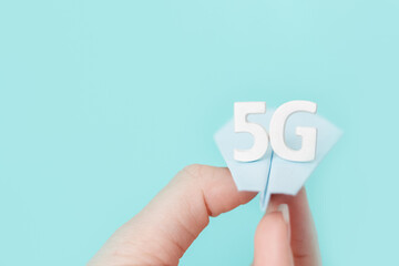 Flying paper plane with large white letters 5 G on blue background. Creative concept. Modern wireless high speed mobile internet. Connection technology for cell, laptop, phone. Use at home, work