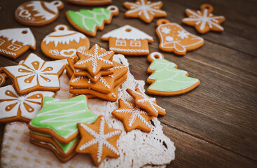 Obraz na płótnie Canvas festive Christmas gingerbread cookies in the shape of a star lie on a wooden dark brown background.