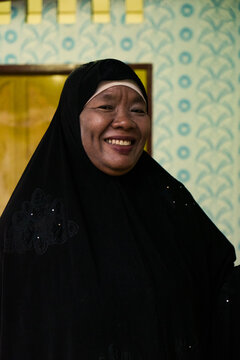 Indonesian old woman portraits wearing black chador smiling
