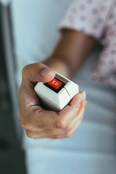 Closeup of Woman Hand Pushing the Emergency Button at the Hospit