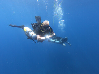 Fototapeta na wymiar Buceadores de buceo técnico realizando ejercicios bajo el mar