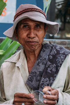 Indonesian old man preparing and selling typical food on the street