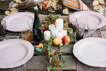 Served picnic table with kitchenware,drink and fruit
