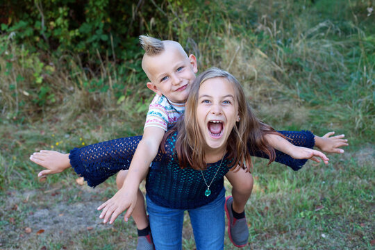 Nine year old girl and her five year old brother goofing off