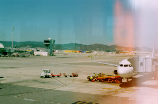 Out-of-focus shot of airplane with loaders